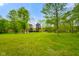 Spacious front yard with mature trees, providing shade and privacy at 12142 N Paddock Rd, Camby, IN 46113