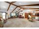 Spacious living area with beamed ceilings and views of kitchen and entry at 12142 N Paddock Rd, Camby, IN 46113
