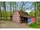 Charming outdoor outbuilding near the river, featuring an American flag accent and ample storage at 12142 N Paddock Rd, Camby, IN 46113