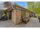 Exterior view showcasing the spacious wooden patio with a bench and sliding doors at 12142 N Paddock Rd, Camby, IN 46113