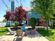 Inviting backyard with a brick patio, a fire pit, Adirondack chairs, and mature landscaping at 13766 Heatherfield Dr, Fishers, IN 46038
