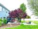 Backyard patio with dining and lounge areas adjacent to a well-maintained lawn and landscaping at 13766 Heatherfield Dr, Fishers, IN 46038