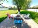 Cozy backyard fire pit area with brick pavers and colorful Adirondack chairs for relaxing outdoors at 13766 Heatherfield Dr, Fishers, IN 46038