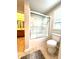 A view of a tub and toilet in the bathroom with a double sink vanity nearby at 13766 Heatherfield Dr, Fishers, IN 46038