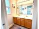 Bright bathroom with a double sink vanity under a large mirror and decorative lighting at 13766 Heatherfield Dr, Fishers, IN 46038