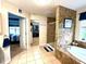 Bathroom featuring a walk-in shower with marble tile, soaking tub and walk-in closet at 13766 Heatherfield Dr, Fishers, IN 46038