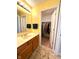 Bright bathroom with a single sink vanity and an open door to a walk-in closet at 13766 Heatherfield Dr, Fishers, IN 46038