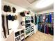 Spacious walk-in closet with custom shelving for clothes, shoes, belts, and hats at 13766 Heatherfield Dr, Fishers, IN 46038