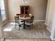Cozy dining room features neutral carpet, wood table with four chairs, and a classic china cabinet at 13766 Heatherfield Dr, Fishers, IN 46038