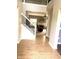 Inviting entryway with hardwood floors, staircase, and view into the living room featuring a fireplace at 13766 Heatherfield Dr, Fishers, IN 46038