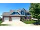 Beautiful two-story home featuring blue siding, brick accents, and a well-maintained lawn at 13766 Heatherfield Dr, Fishers, IN 46038