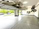 Clean and organized garage featuring an epoxy floor and overhead storage at 13766 Heatherfield Dr, Fishers, IN 46038
