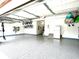 Spacious garage with epoxy flooring and overhead storage racks at 13766 Heatherfield Dr, Fishers, IN 46038