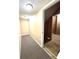 Hallway with carpet leads to open unfinished basement area with pink insulation visible at 13766 Heatherfield Dr, Fishers, IN 46038