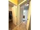 Hallway view showing two open doors to a walk-in closet and a bathroom at 13766 Heatherfield Dr, Fishers, IN 46038