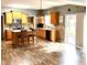 Spacious kitchen with wood cabinetry, stainless steel appliances, tiled backsplash, island with seating, and sliding door access at 13766 Heatherfield Dr, Fishers, IN 46038