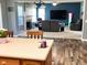 Open-concept living room with a fireplace, comfortable seating, and stylish decor visible from the kitchen at 13766 Heatherfield Dr, Fishers, IN 46038