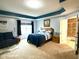 Spacious main bedroom with king bed, sitting area, blue accents, and an ensuite bathroom at 13766 Heatherfield Dr, Fishers, IN 46038