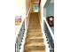 Wooden staircase with decorative black metal railings leads to the next level of the home at 13766 Heatherfield Dr, Fishers, IN 46038