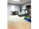 Basement workout room featuring exercise equipment, a table with chairs, and a sleek television at 13766 Heatherfield Dr, Fishers, IN 46038