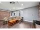 Spacious basement featuring a comfortable sectional sofa and a charming brick accent wall at 1416 Wellington Ave, Indianapolis, IN 46219