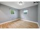 Sun-filled bedroom with hardwood floors and two windows at 1416 Wellington Ave, Indianapolis, IN 46219