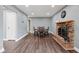 Dining area with wood floors, fireplace, and overhead lighting is ideal for Gathering gatherings at 1416 Wellington Ave, Indianapolis, IN 46219