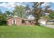 Charming brick home with attached garage and lush green lawn in a well-maintained neighborhood at 1416 Wellington Ave, Indianapolis, IN 46219