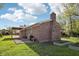 Brick home with a covered patio and a well-maintained lawn, offering a serene outdoor space at 1416 Wellington Ave, Indianapolis, IN 46219