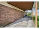 Brick home exterior featuring a covered walkway and a well-maintained lawn at 1416 Wellington Ave, Indianapolis, IN 46219