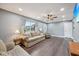 Comfortable living room with wood floors, ceiling fan, recessed lights, large windows, and ample seating at 1416 Wellington Ave, Indianapolis, IN 46219
