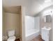 Cozy bathroom with white fixtures including a toilet, tub/shower combo, and vanity sink at 1425 S Belmont Ave, Indianapolis, IN 46221