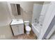 Neat bathroom equipped with vanity, toilet, and tub-shower combo at 1425 S Belmont Ave, Indianapolis, IN 46221