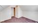 Slanted bedroom with neutral walls, carpet, and doorways leading to other rooms at 1425 S Belmont Ave, Indianapolis, IN 46221