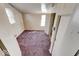 Small bedroom with neutral walls, multiple windows, doors, and purple carpet at 1425 S Belmont Ave, Indianapolis, IN 46221
