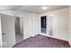 Cozy bedroom with white wainscoting, an overhead light and doorways leading to other rooms at 1425 S Belmont Ave, Indianapolis, IN 46221