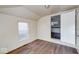 Bedroom featuring hardwood floors, a window, and an open doorway leading to another room at 1425 S Belmont Ave, Indianapolis, IN 46221