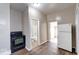 Compact kitchen area featuring an oven, refrigerator, and easy access to the bathroom at 1425 S Belmont Ave, Indianapolis, IN 46221
