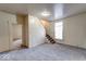 View of the carpeted living room with staircase, window, and doorways leading to other rooms at 1425 S Belmont Ave, Indianapolis, IN 46221