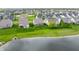 An aerial view of a community featuring well-maintained homes, green lawns, and a serene pond at 14878 Anees Ln, Fishers, IN 46040