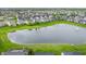 A picturesque aerial view captures a pond surrounded by homes and verdant landscapes at 14878 Anees Ln, Fishers, IN 46040