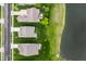 An aerial view of homes each with a backyard with patio, and next to the community's pond at 14878 Anees Ln, Fishers, IN 46040