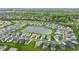 Panoramic aerial view of a community encircling a tranquil pond, boasting meticulously maintained landscaping at 14878 Anees Ln, Fishers, IN 46040