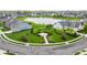 A scenic aerial view showcases a community pond, gazebo, and a manicured entrance at 14878 Anees Ln, Fishers, IN 46040