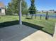 Backyard with a patio, grass and wrought iron fence with a pond view at 14878 Anees Ln, Fishers, IN 46040