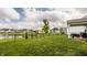 Spacious backyard with a pond view, wrought iron fence, and green lawn at 14878 Anees Ln, Fishers, IN 46040