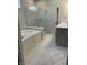 Luxurious bathroom showcasing a soaking tub, glass shower, and marble floors at 14878 Anees Ln, Fishers, IN 46040