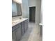 Modern bathroom featuring double vanity with stone countertop and marble flooring with an open closet at 14878 Anees Ln, Fishers, IN 46040