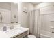 This bathroom includes a shower-tub, gray vanity with quartz countertop, and chrome faucet and fixtures at 14878 Anees Ln, Fishers, IN 46040