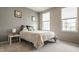 Cozy bedroom with soft natural light from two windows featuring gray walls and neutral carpet at 14878 Anees Ln, Fishers, IN 46040